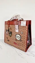 Load image into Gallery viewer, Field Tote 40 in Signature Canvas with Souvenir Patches and Pins Empire State Rexy - Tan Rust Saddle Brown Shoulder Bag Crossbody - Coach C0768