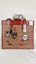 Load image into Gallery viewer, Field Tote 40 in Signature Canvas with Souvenir Patches and Pins Empire State Rexy - Tan Rust Saddle Brown Shoulder Bag Crossbody - Coach C0768
