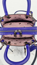 Load image into Gallery viewer, Disney x Coach 1941 Rogue 25 Dark Fairytale Purple with Black Flowers on Suede - LIMITED EDITION Coach 32778Disney x Coach 1941 Rogue 25 Dark Fairytale Purple with Black Flowers on Suede - LIMITED EDITION Coach 32778
